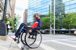 © Connect Images - Man in wheelchair who had Spinal Meningitis going over a curb
