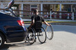© Connect Images - Man who had Spinal Meningitis in wheelchair entering his accessible vehicle