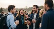 © Feloz - Group of friends socializing and laughing outdoors at a casual evening gathering.