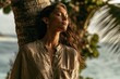 © Minerva Studio - Woman relaxing leaning on palm tree feeling tropical sunset