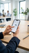 © Thumbs - Person analyzing financial growth chart on smartphone in office
