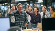 © Ilmi - Entrepreneurs Celebrating Successful Product Launch in Modern Office Environment with Enthusiastic Expressions