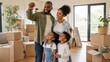 © Tati - Smiling family celebrates moving into their new home as father holds keys amid packed boxes and bright living room