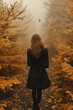 © Ekaterina - Woman walking through forest with leaves on head.