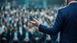 © Sukon - A business leader delivering a speech to a large audience to drive corporate culture.