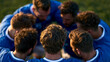 © Anastasiia Havelia - A European football team viewed from above huddles softly on a bright sunny field planning a calm play in soft daylight, football huddle, faceless top view, bright outdoors, daylig
