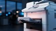 © Funster - Close-up of a modern office printer processing a stack of paper in a business environment.