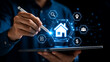 © RA_DESINER - Man interacting with futuristic digital interface displaying real estate icons and network connections.