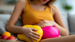 © Aliaksandra - Woman holding hot water bottle against abdomen, concept of menstrual cramps, stomach pain, home care and wellness