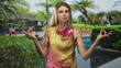 © Krakenimages.com - Woman with hands forming ok gesture and closed eyes meditating by a hotel poolside, palms visible and relaxed; serenity.