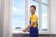 © New Africa - Professional worker examining window after installation indoors