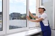 © New Africa - Professional worker examining window after installation indoors