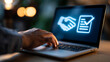 © Kateryna - A close up of a European businessman hand uses softly a calm laptop with glowing handshake and contract approval icons in a moody office procurement concept faceless detail