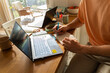 © Alba Vitta Studio/Stocksy - Man Working on Laptop and Writing Notes