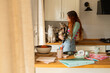 © Alba Vitta Studio/Stocksy - Woman  With Cats in a Kitchen