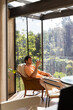 © Alba Vitta Studio/Stocksy - Man Sitting on a Chair and Using  Phone sundeck