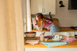 © Alba Vitta Studio/Stocksy - Woman  With Cats in a Kitchen