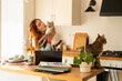 © Alba Vitta Studio/Stocksy - Woman Enjoys Time With Cats While Working from home