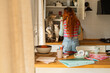 © Alba Vitta Studio/Stocksy - Woman in Kitchen With Cats on the Counter
