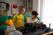 © Zoran Jesic - Boys repairing rc car learning engineering skills together