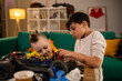 © Zoran Jesic - Boys repairing remote control car hobby bonding