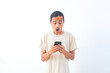 © Ari Kusumastuti - Young Asian man in a shirt, with a shocked face expression. Isolated on a white background