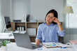 © Phimwilai - Tired businesswoman rubbing eyes working late in office