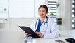 © Fahng - Asian female GP doctor looking away with friendly smile, relish her professional success, feel satisfied with career, thinks about future achievements.