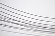 © Kwangmoozaa - Many electric wires and cables running across bright white sky background