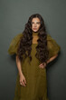 © millaf (Nemchinova) - Indoor portrait of long hair woman classic hairs curly. Brunette model with wavy hair looking at camera