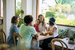 © Westend61 - Happy friends with child socializing in cozy cafe