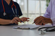 © MINAE - Healthcare professionals collaborating on medical records, discussing patient care, developing treatment plans, and consulting on diagnosis results in a clinic setting