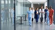 © gg - Diverse group of medical professionals walking down a modern hospital corridor, discussing patient care.