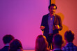 © Lustre Art Group  - Male presenter explaining strategy to audience in colorful seminar room. Concept of business presentation, team training, executive workshop, communication skills and leadership coaching.