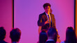 © Lustre Art Group  - Male presenter guiding audience discussion in neon seminar room. Concept of public speaking, business training, leadership workshop, coaching event and interactive seminar.