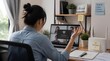 © Fariqul - Woman at desk frustrated by no internet connection on laptop