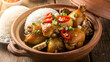 © ehab - Vietnamese ginger chicken dish, ga kho gung, braised chicken with ginger, caramelized sauce, served in a clay pot, garnished with scallions and chili, steamed jasmine rice on the side