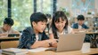 © Attasit - Young Students Engage with Technology in Classroom
