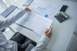 © Wanda - Busy businessman checking document in office