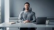 © TransPicHub - A man with closed eyes sits calmly at a desk in an office, meditating or practicing mindfulness to reduce stress.