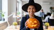 © Morrina - Halloween office celebration businesswoman proudly displaying carved pumpkin lantern for corporate newsletter magazine cover workplace culture promotion