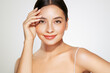 © Oleg Gekman - Skin care. Woman with beauty face touching healthy facial skin portrait. Beautiful girl model with natural makeup touching glowing hydrated skin on white background closeup