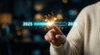 © Masque - Female hand sliding a loading bar from 2025 to 2026 on a virtual screen for Happy New Year.