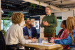 © Rido - Multiethnic business people discussing project in a meeting room