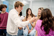 © alvaro - Diverse students talking and laughing in classroom