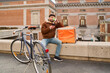 © Oscar - Courier taking coffee break checking smartphone