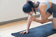 © 9nong - Strong, fit, disciplined fitness Asian woman working out in indoor gym with elbow to knee table top pose