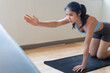 © 9nong - Strong, fit, disciplined fitness Asian woman working out in indoor gym with table top pose, showing facial expression