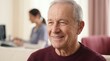 © Megin Design - Smiling elderly man wearing a behind the ear hearing aid. Senior male patient receiving audiologist care in a medical clinic