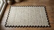 © Khadija - A cozy, textured scalloped edge rug made from natural fibers laid on a rustic wooden surface.